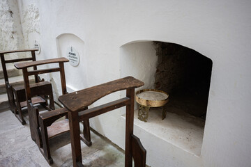 Historical Catholic columbarium with aged wooden pews and spiritual atmosphere
