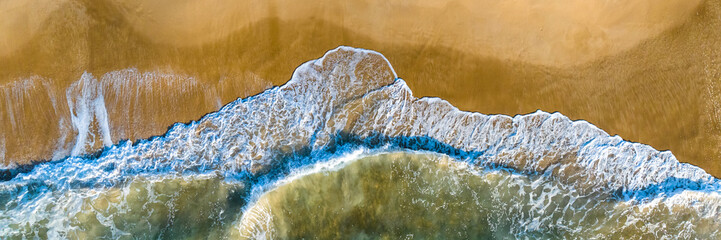 Florianópolis, Campeche beach during sunrise. Brazil. Rio Tavares neighborhood. Wave formation in web banner aerial view.