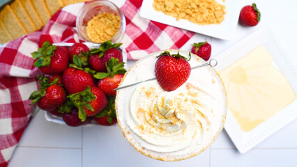 Making Strawberry Shortcake Martinis for a Spring party in the garden.  Using red gingham napkins to place our fruity dessert martinis on.  Close up of strawberries in the summertime. Cocktails 