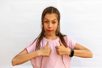 Teenage girl with ponytail shows like with both hands, like something excellent, praise and approve, give positive feedback, standing pleased against white background