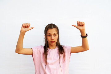Teen girl pointing with thumbs behind her back. Advertisement space above on white background