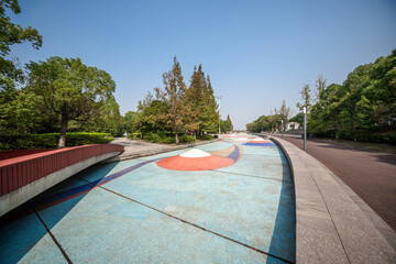 Serene Urban Park Scene with Colorful Walkway and Lush Greenery