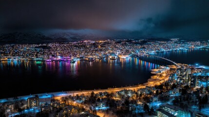 Fototapeta premium Aerial Night View of Tromsø City and Bridge with Colorful Reflections