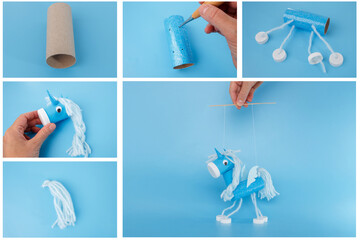 Blue handmade unicorn puppet made from recycled materials held by hand on white background perfect...
