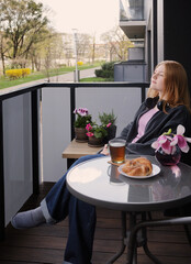 beautiful teenager girl  with cup of tea on balcony