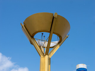 A tall gold colored structure with a dome on top