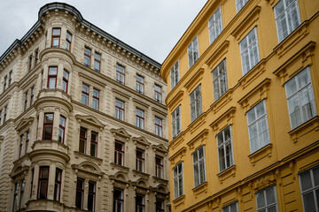 Historic European architecture with ornate facades and yellow building corner view, Vienna, Austria