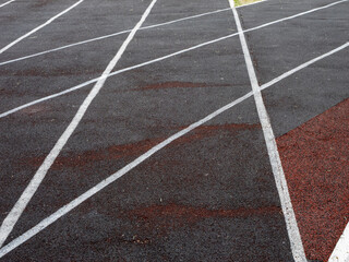 A track with white lines and a red line