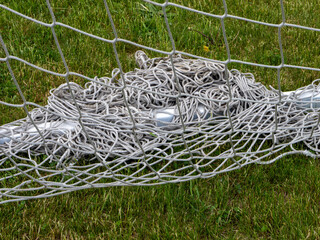 A soccer net with a bunch of strings on it