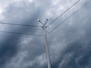 A tall pole with two street lights on top of it