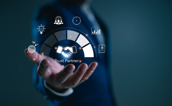 Trust partnership concept with businessman holding digital handshake icon, representing reliable cooperation, strategic success, long-term business relationships, B2B marketing, consulting. - Powered by Adobe