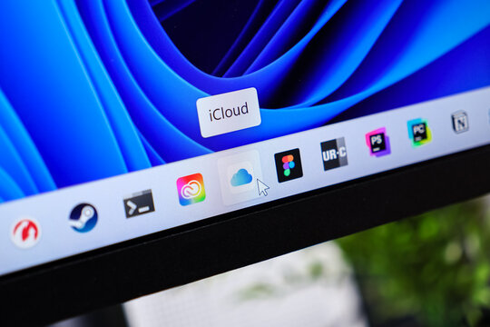 Poznan, Poland - June 6, 2025: iCloud application icon on a Windows 11 taskbar, with a mouse cursor hovering above it, illustrating cloud storage data management