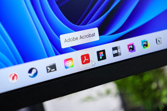 Poznan, Poland - June 6, 2025: Adobe Acrobat application icon displayed on the Windows 11 taskbar, with a cursor hovering, signifying modern document software