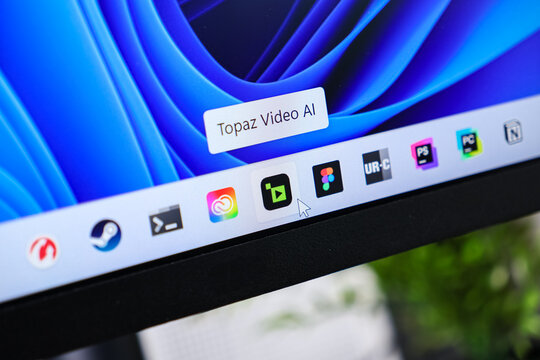 Poznan, Poland - June 6, 2025: Topaz Video AI application icon with mouse cursor on Windows 11 taskbar, highlighting advanced video editing software