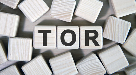 TOR text on wooden square cubes surrounded by other cubes