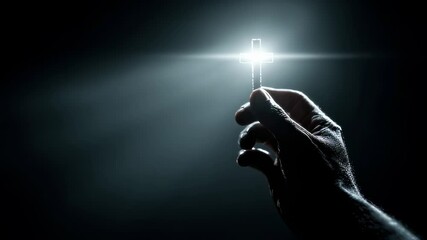 Shadowy silhouette of a persons hand reaching out to hold a glowing cross, symbolizing the guiding light of faith in the darkness.
