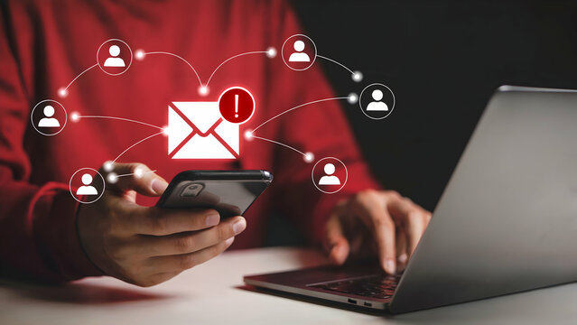 Urgent Email Alert Notification A Person Checks Their Smartphone and Laptop for a Critical Mass Email Message Showing Network Connections and Warning Signs of a System Security Breach or Data Threat
