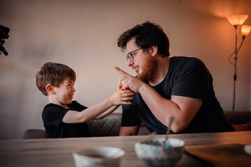Father and Son Sharing a Playful Moment in the Kitchen