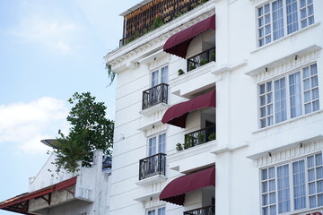 Elegant White Building with Red Awnings Architectural Design and Exterior Details