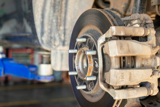 Fototapeta Car wheel disc brake and caliper part that disassembled from inspection. Vehicle equipment part object, close-up with selective focus.