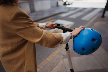 Image of woman using e scooter in town, close up