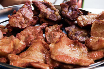 Thai food. Roast meat, pork pieces on a table dish