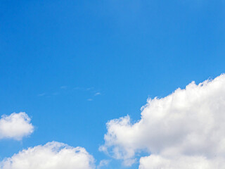 White clouds scattered in the clear blue sky. Sky and clouds landscape. Sky background