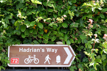 A public footpath sign directs walkers and cyclists along the long distance Hadrian's Way in...