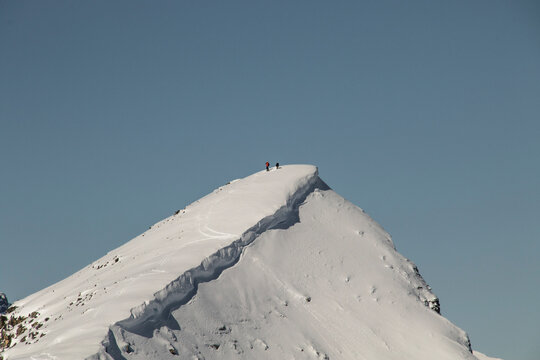 Climbers on mountain peak during winter