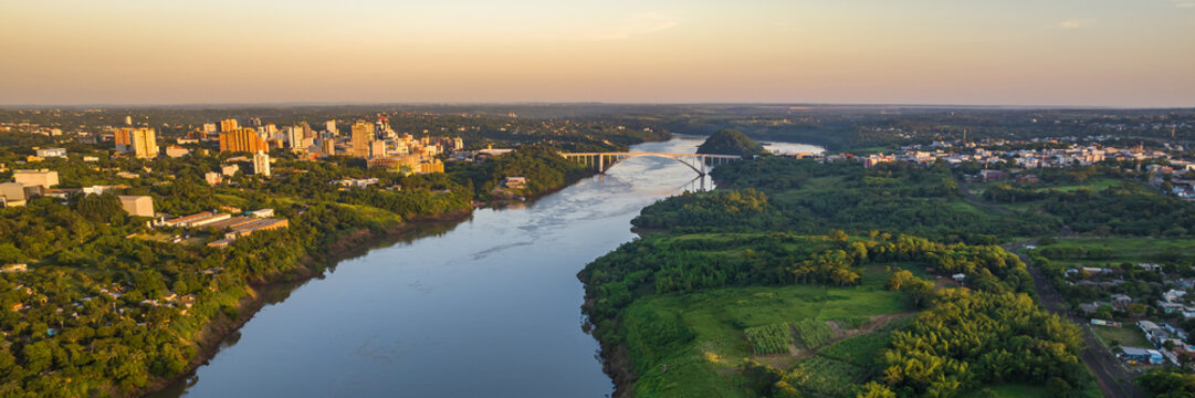 Border between Brazil and Paraguay and connects Foz do Iguacu to Ciudad del Este. Ponte da Amizade in Foz do Iguacu. Aerial view of the Friendship Bridge with Parana river. Web banner in aerial view.