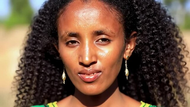 Beautiful Ethiopian Woman with Radiant Brown Skin & Golden Undertones, Large Bright Eyes and Traditional Earrings &ndash; Sunlit Elegant Portrait + Concept
