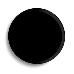 Black circular object, likely a button or disc, on a white background.  A shadow suggests a three-dimensional form