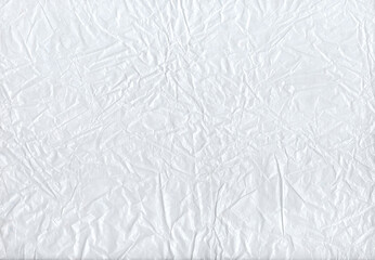 Crumpled white paper close-up.
The texture of crumpled white paper with lots of folds, kinks and shadows. It is suitable as a background or textural element for design, collages and creative projects.
