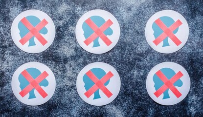 Obraz premium Six circular stickers, light blue female head silhouettes with red crossed-out symbols, arranged on dark textured surface