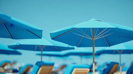 Aerial view of symmetrical triangle formation made from blue beach umbrellas and lounge chairs on sandy shore, capturing a relaxing summer vacation setup by the sea