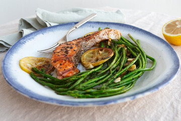 plate of grilled salmon with asparagus on the table