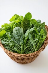 Fototapeta premium Fresh Green Leafy Vegetables in Woven Basket on White Background
