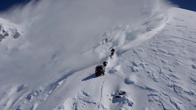Summit Ascent: A group of daring climbers faces the harsh mountain and challenges, as they ascend a snow-covered peak, a testament to human resilience and the allure of adventure. 
