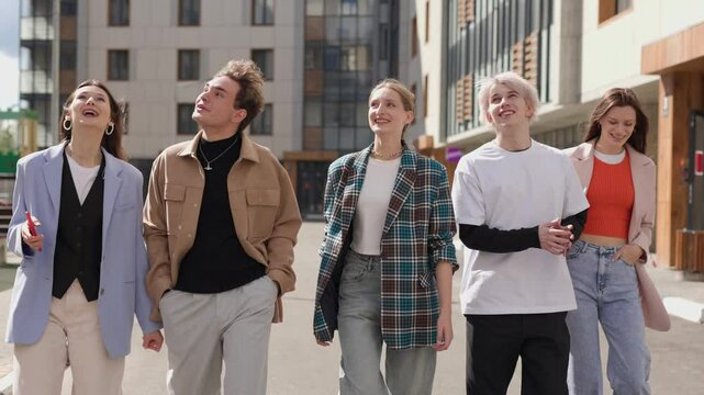 Diverse fashionable friends strolling together, sharing smiles and laughter, enjoying vibrant city energy and camaraderie