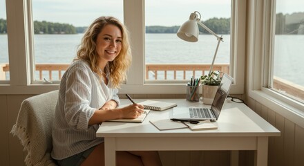 Woman working at desk by lake window