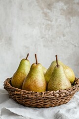 Fresh Pears in a Woven Basket on a Light Textured Background