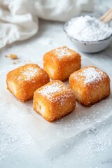 Delicious Golden Brown Fried Treats with Powdered Sugar Dusting