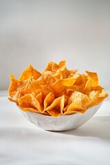 Crispy Golden Tortilla Chips in a White Bowl on Soft Surface