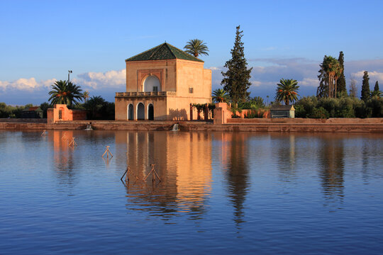 Morocco, Marrakesh, Menara Pavilion reflected on the lake in late afternoon sunshine.