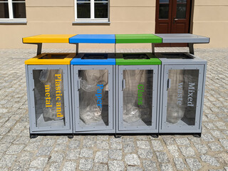 Modern outdoor recycling station with color-coded bins for plastic and metal, paper, glass, and...