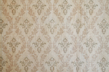 Old wallpaper on the wall. Old wallpaper for texture or background.
