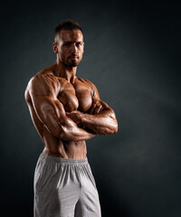 portrait of a muscular young man with his arms crossed