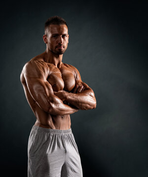 portrait of a muscular young man with his arms crossed