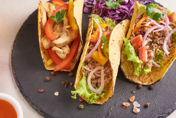 Mexican tacos with meat, pork carnitas street tacos in yellow corn tortilla with onion, cilantro and cabbage. red cabbage. Top view. flat lay.