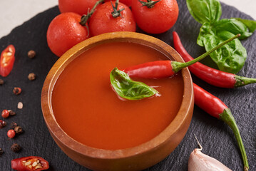 
red hot chilli sauce. tomato ketchup, chilli sauce, puree with chili pepper, Vegetables, tomatoes and garlic. on on black stone background. top view